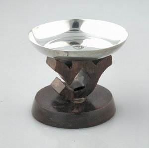 Small Circular Silver Dish Sits Atop a Platform - Photo 1