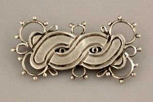 Twisted Wire Pin Resembling an Aztec Mask - Photo 1