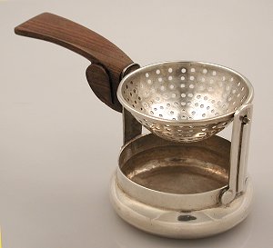 Tea Bag Holder Suspended Over a Silver Bowl - Photo 1